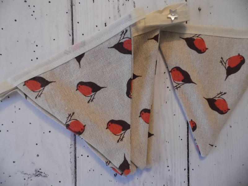 Handmade Christmas bunting in a cream fabric with a cheery Robin on Cream tape